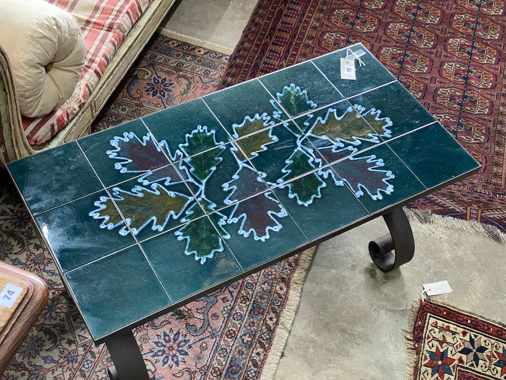 A 1970's wrought iron tile top coffee table, length 90cm, depth 45m, height 42cm